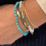 KImolos-bracelet_artisanal_Mymosaa_en_perles_etcordon_turquoise_or__argent_porte_avec_bracelets